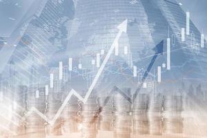 Multi exposure of virtual creative financial chart hologram on growing stacks of coins background photo