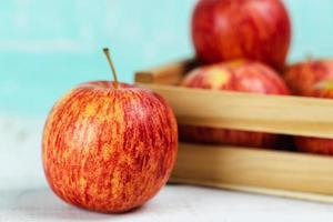 Fresh red apples on wooden background.