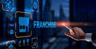 Businessman hand touching inscription Franchise marketing system photo