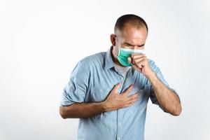 Man wearing face mask sneezing or coughing over his hand to prevent spread the virus COVID-19 or Corona Virus on white background.