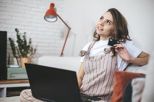 Young millennial woman shopping online at home. photo