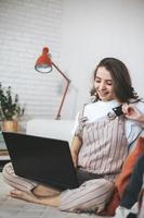 Young millennial woman shopping online at home. photo