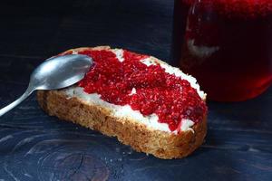 Traditional food. Raspberry jam and bread with butter.