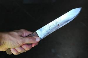 Knife in the hands of a criminal or murderer. photo