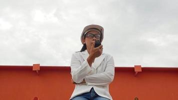 Female engineer in a white helmet using radio communication at the dam construction site to generate electricity. Clean energy and Technology concepts. video