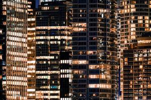 Facade windows of illuminated modern skyscraper with office building photo