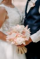 elegant wedding bouquet of fresh natural flowers and greenery photo