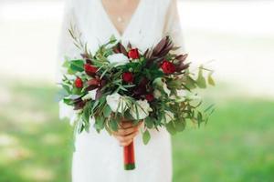 wedding bouquet of red flowers and greenery photo