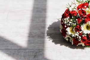 brides bouquet on a vintage wooden floor photo