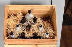 empty wine bottles in a wooden box photo