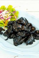 Fried squid with squid ink sauce - seafood style photo