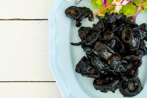 Fried squid with squid ink sauce - seafood style photo