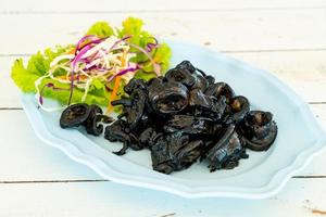 Fried squid with squid ink sauce - seafood style