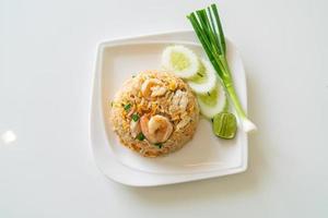Fried rice with shrimp and crab on white plate photo
