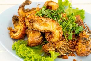 Fried crayfish or mantis shrimps with garlic - seafood style photo