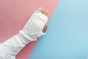 Injured painful hand with bandage photo