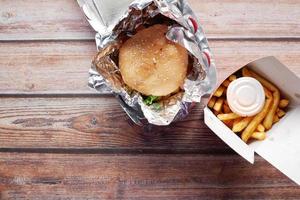 Beef burger in a take away box on table photo