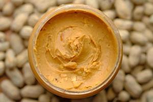 Top view of peanut butter in a container photo