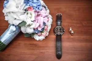 wedding ring and watch groom on the table photo