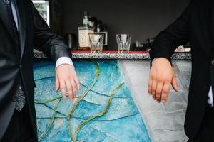 two guys at the bar drink whiskey from crystal glasses photo