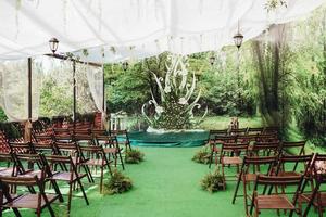 wedding ceremony in the woods among the trees on the green track photo
