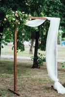 wedding ceremony in the woods among the trees on the green track photo