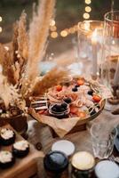 atmospheric candle decor with live fire on the banquet table photo