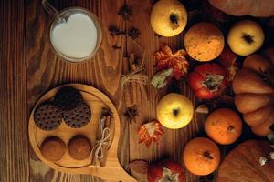 Chocolate cookies, vegetables, fruit and milk in a mug. photo