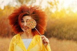 Portrait of a smiling girl dressed in raincoat. photo