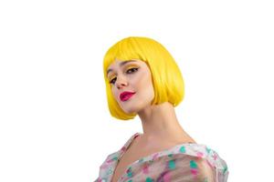 Hipster girl in in yellow wig isolated on white background. Close up portrait of cheerful woman wearing in raincoat photo