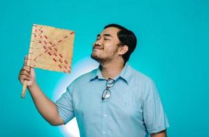 The young man makes a funny face with a blue background. Funny expression. photo