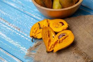 Egg fruit Canistel Yellow Sapote Pouteria campechiana Kunth Baehni on blue wooden table photo
