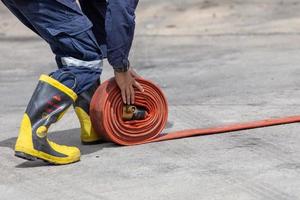 Firemen in firefighter uniform are keep their equipment after use photo