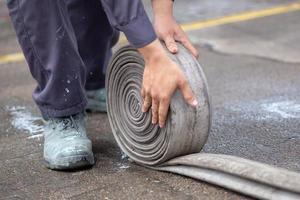 Firemen in firefighter uniform are keep their equipment after use photo