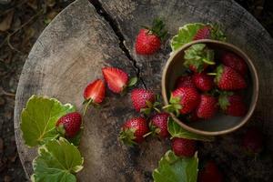 Strawberry In a bowl On a Wooden Background photo