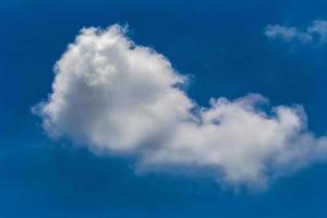 White fluffy clouds in the blue sky background photo