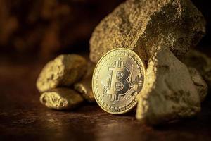 Gold bitcoin physical Bitcoin Cryptocurrency and Gold nugget grains. photo