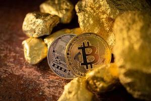 Gold bitcoin physical Bitcoin-Cryptocurrency and Gold nugget grains. Business concept photo