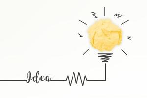 Creativity inspiration, ideas and innovation concepts with lightbulb and paper crumpled ball. photo
