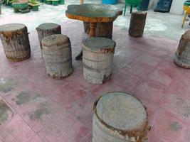 table and stool from tree on park photo