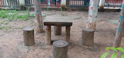 table and stool from tree on park photo