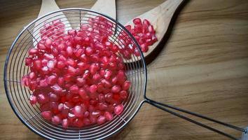 pomegranate seeds stock on net spoon photo