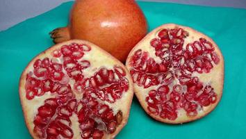 pomegranate closeup on cyan background photo