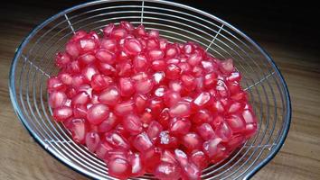 pomegranate seeds stock on net spoon photo