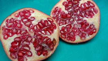 pomegranate closeup on cyan background photo