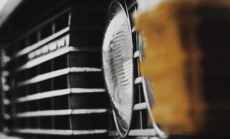 Close-Up Classic Vintage Car Front Grill and Headlight detail photo