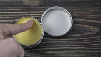 A Man Smears On His Finger Wax Beard And Mustache photo