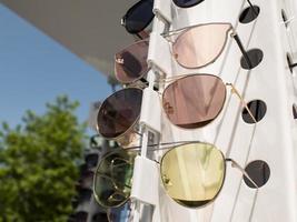 sun glasses on the counter. three pairs of sunglasses in different colors photo