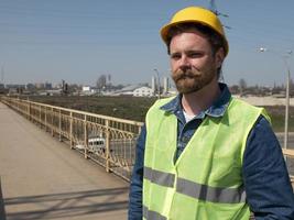 man in a helmet is standing on the bridge photo