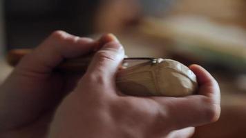 a woodcarver carves a helmet of a robot or a knight video